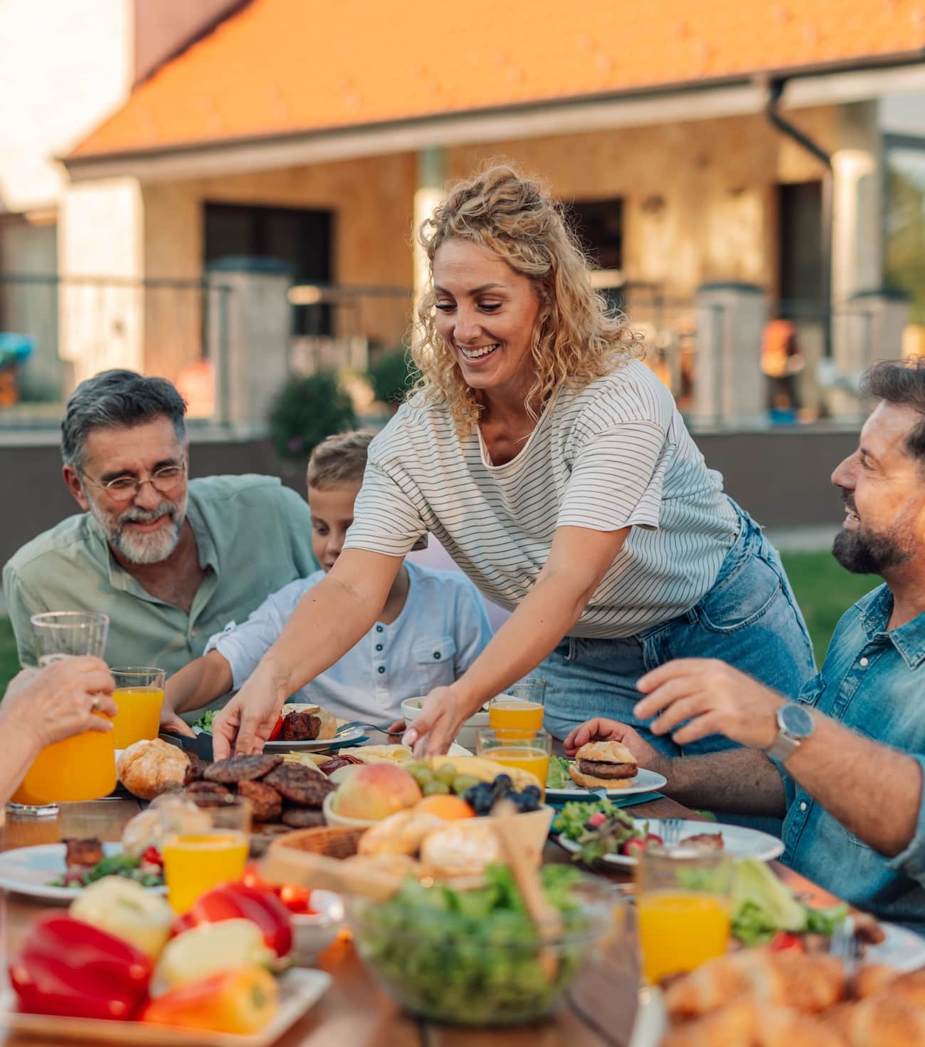 a group of people sitting at a table with food